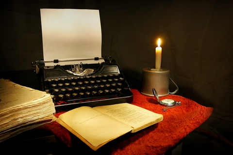 typewriter, candle and books of a writer